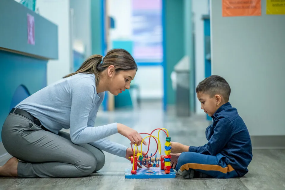 Professional therapist working with child